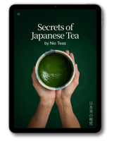 A tablet device displaying a book or ebook cover titled "Secrets of Japanese Tea" by Nio Teas, with a dark green background, white text, and a photo of hands holding a cup of green tea. The tablet is centered on a light gray background with a soft shadow.